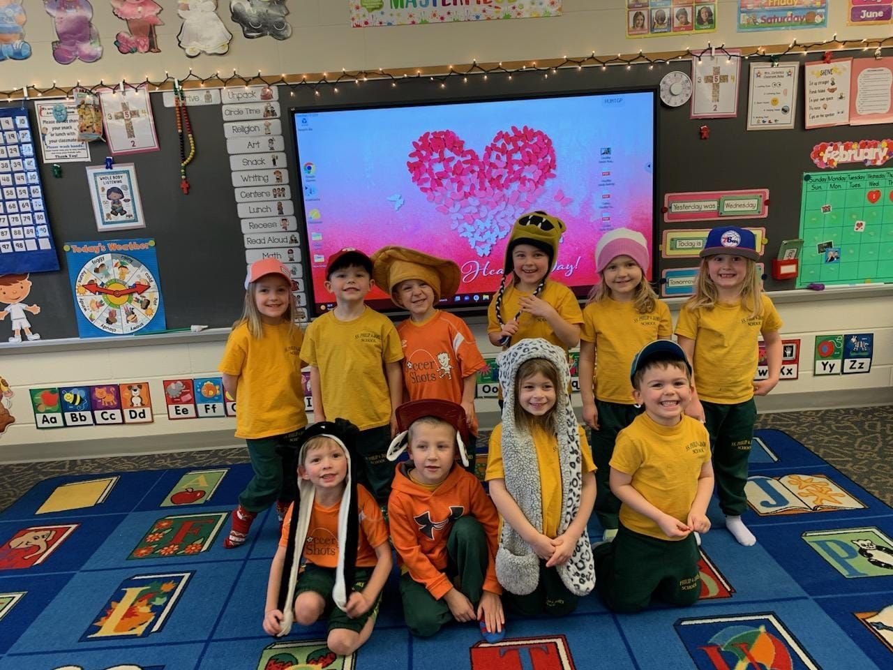 A group of children are posing for a picture in a classroom.