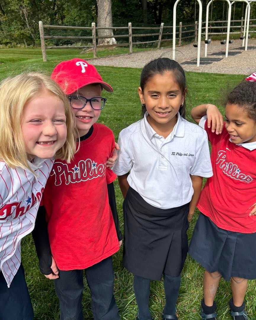 A group of children are posing for a picture in a park.