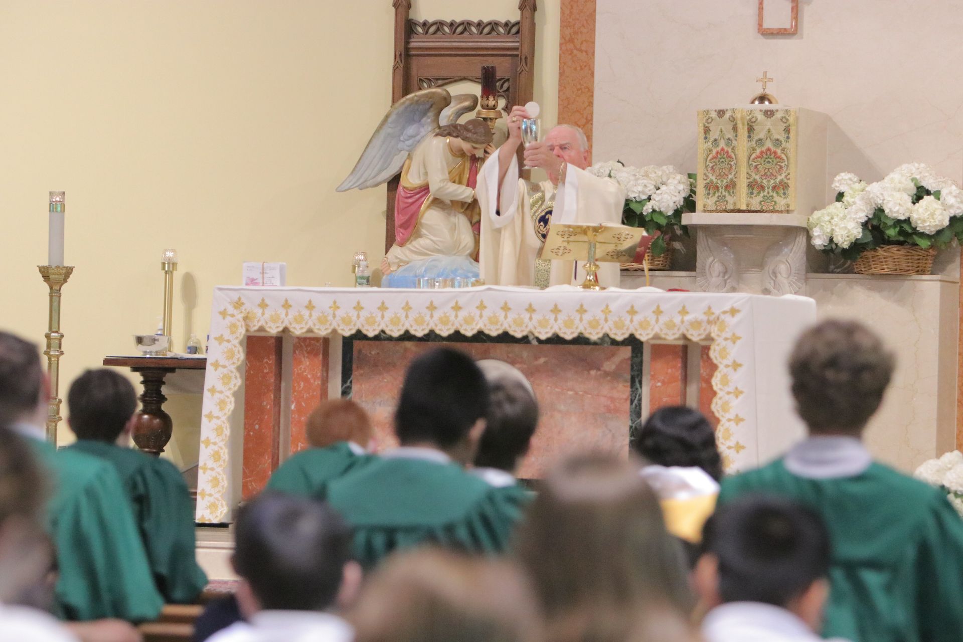 A group of people are sitting in front of an altar in a church.