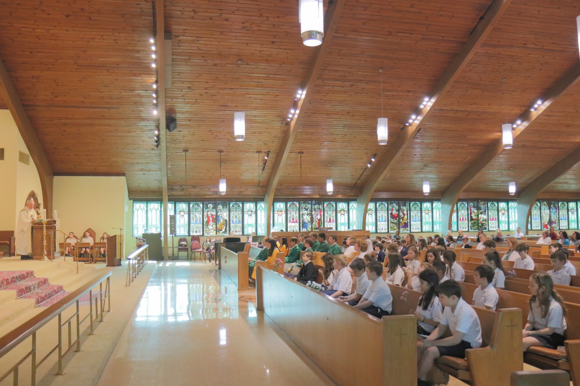 A large group of people are sitting in a church.