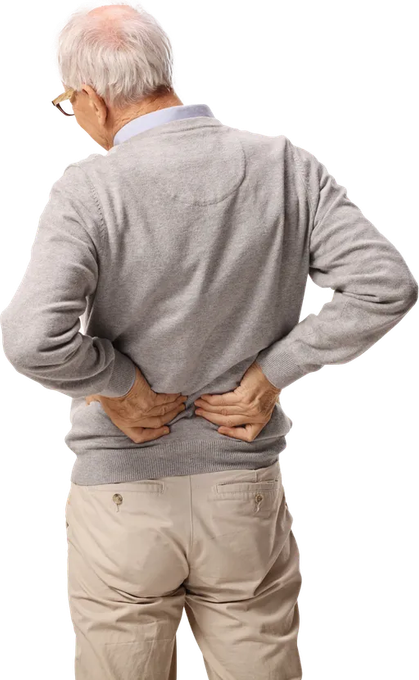 An individual facing away from the camera, clutching their lower back with both hands, suggesting pain or discomfort.