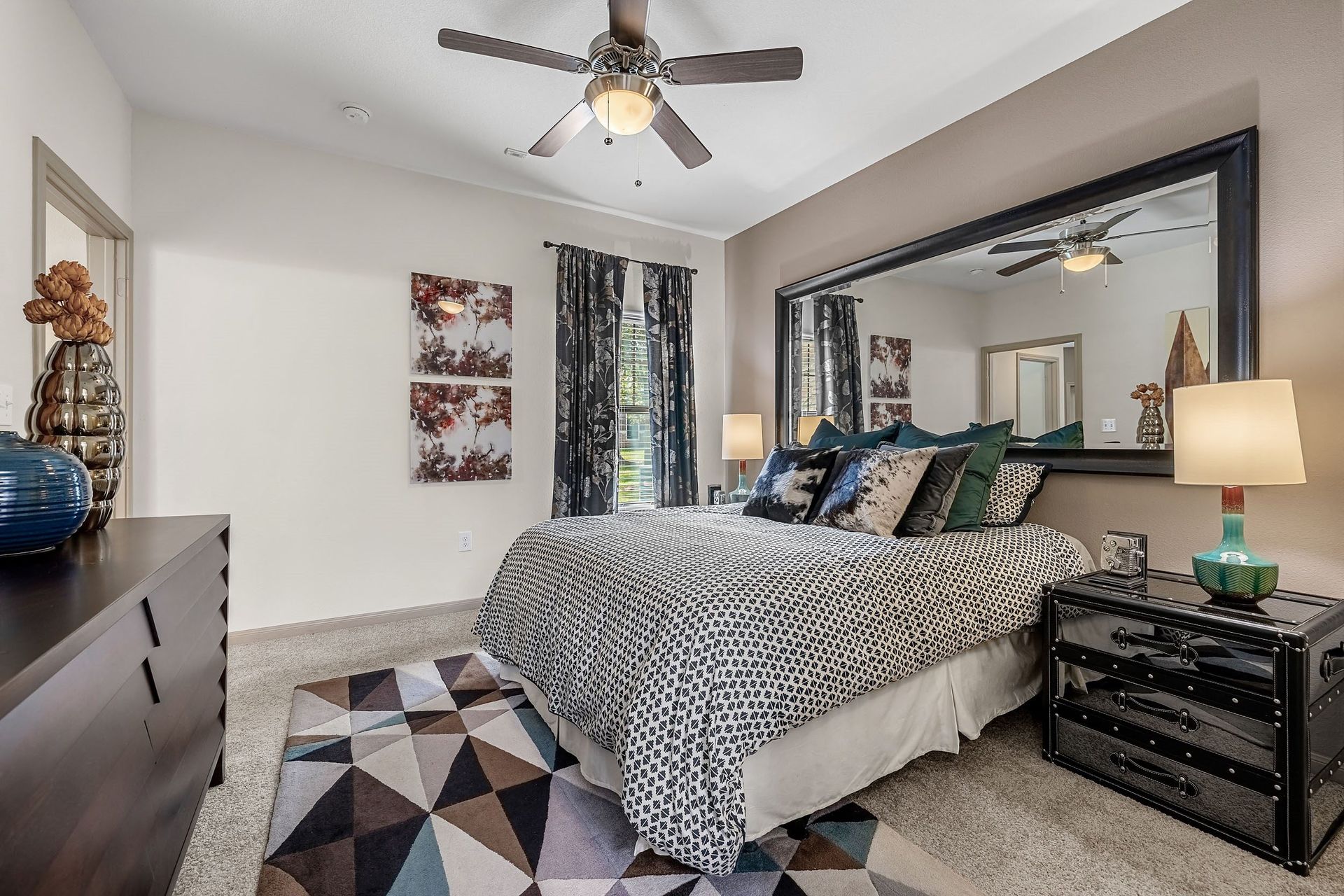 a bedroom with a bed and a ceiling fan