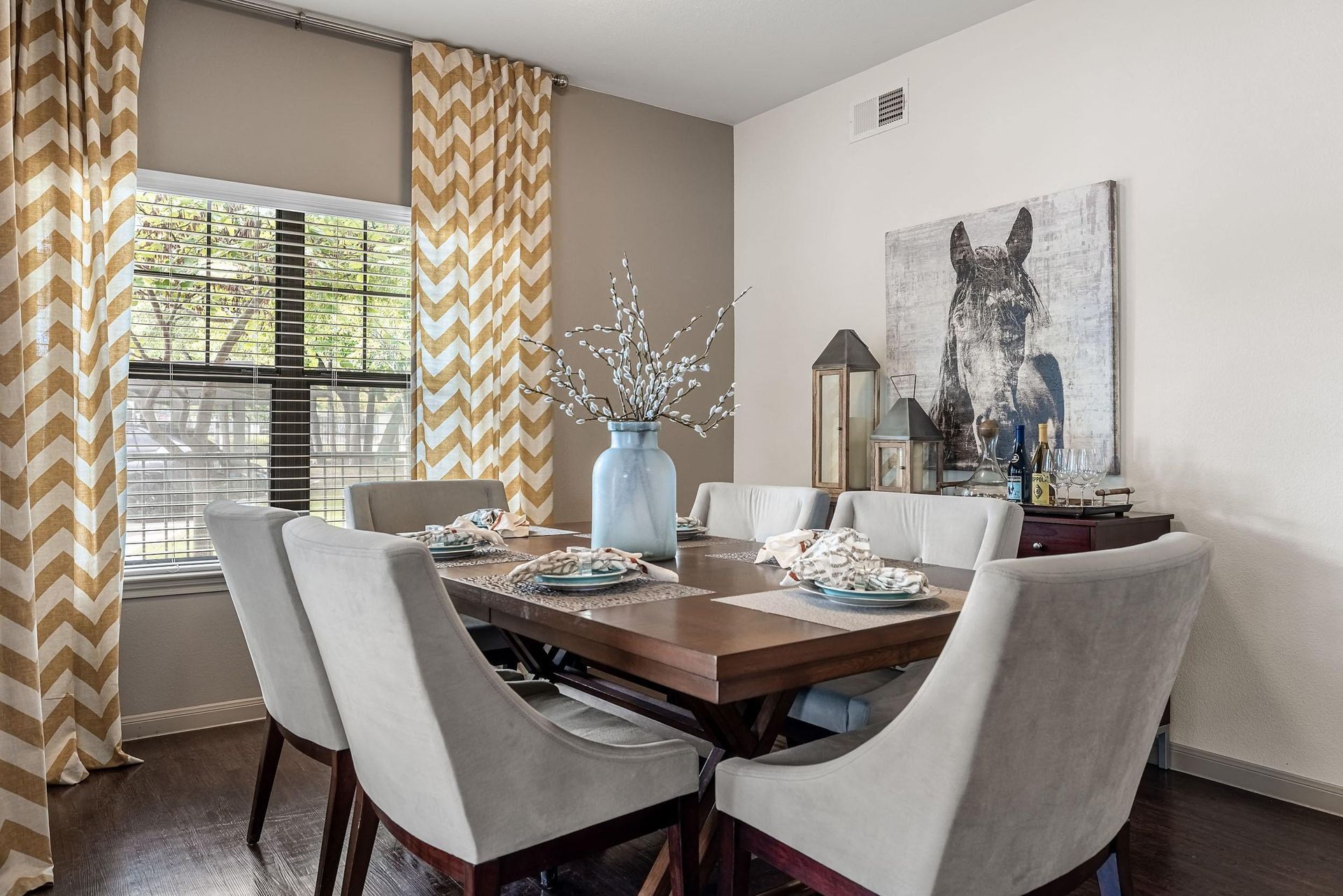 an image of a dining room with a table and chairs