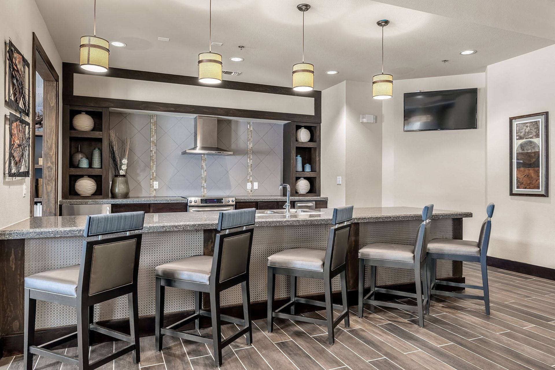 a large kitchen with a bar and chairs