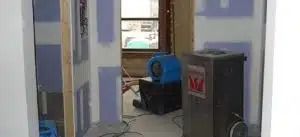 Office hallway with a blue machine and a black cabinet near a doorway