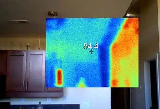 Thermal view of a kitchen wall and cabinets with a temperature reading of 54.4°