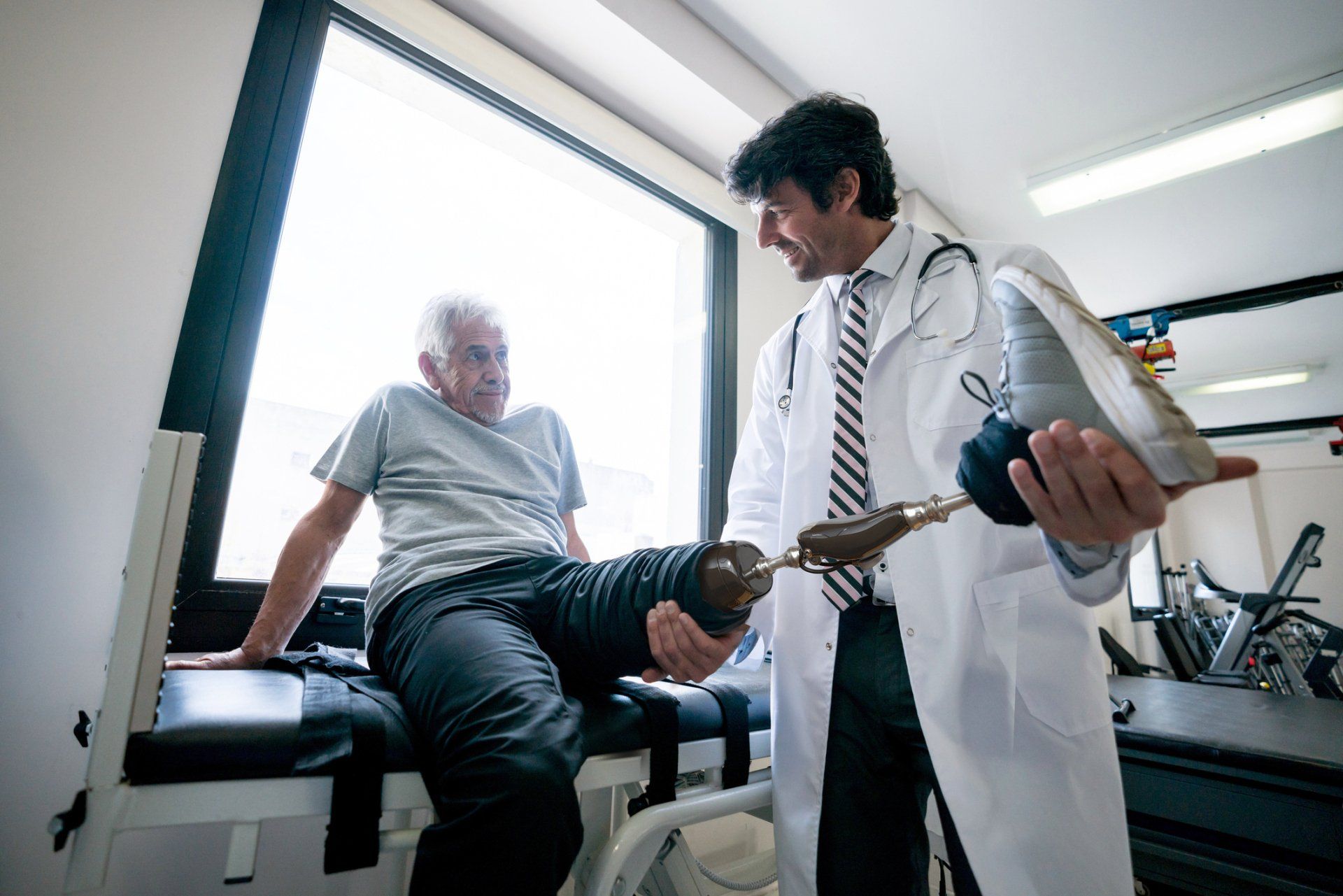 Prosthetists Checking The Prosthetic Leg Of His Client — Greenwood, SC — Carolina Prosthetics & Orthotics Prosthetists Checking The Prosthetic Leg Of His Client — Greenwood, SC — Carolina Prosthetics & Orthotics