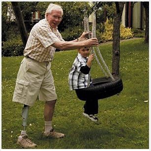 Old Man Playing With A Young Boy — Greenwood, SC — Carolina Prosthetics & Orthotics Old Man Playing With A Young Boy — Greenwood, SC — Carolina Prosthetics & Orthotics