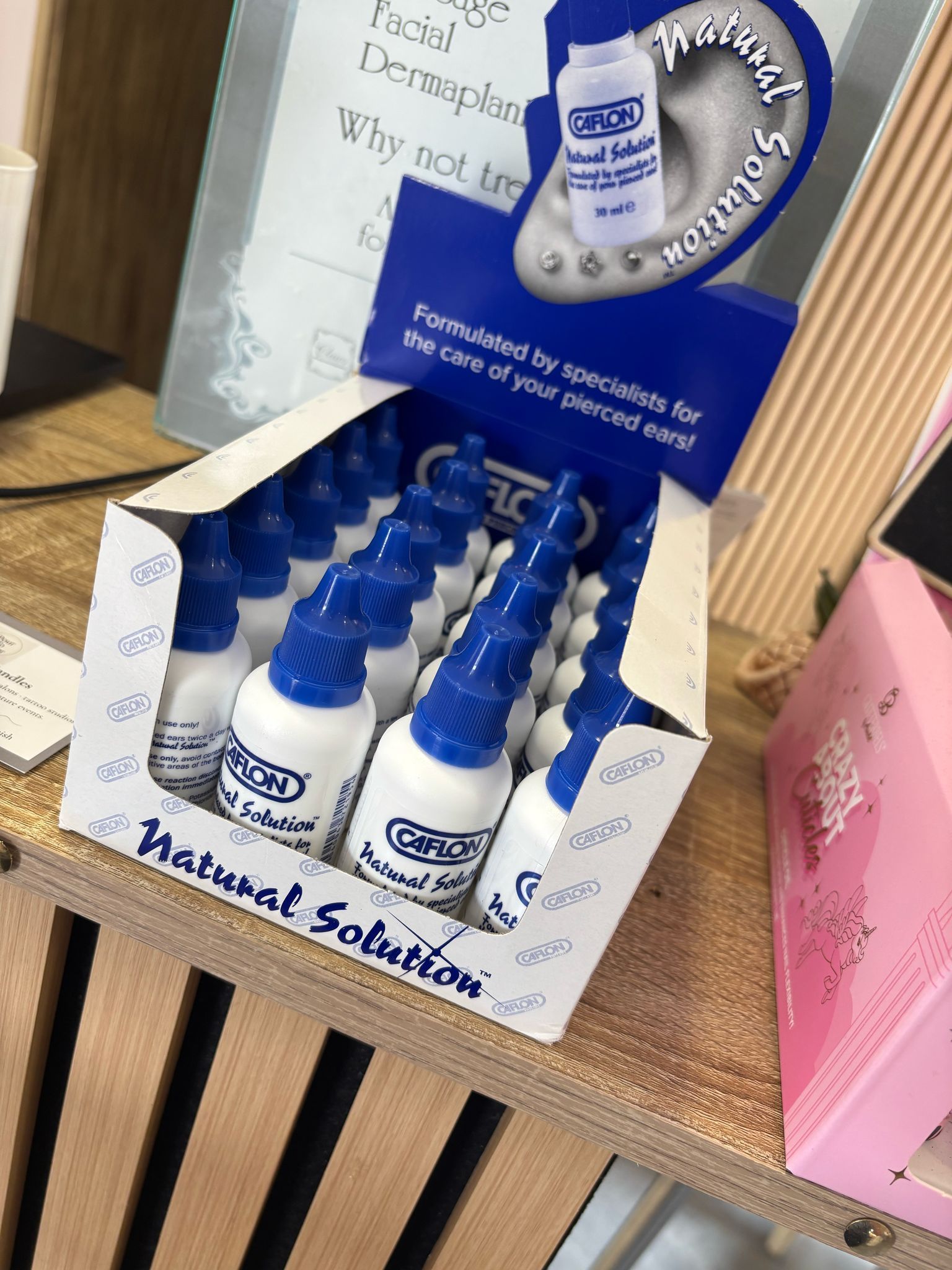 Box of ear piercing aftercare solution bottles on display at Claws Nail and Beauty in Daventry