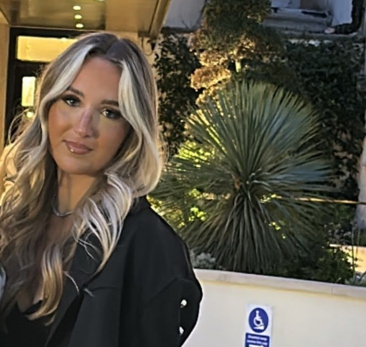 Savannah at Claws Nail and Beauty, with long blonde hair and a black jacket