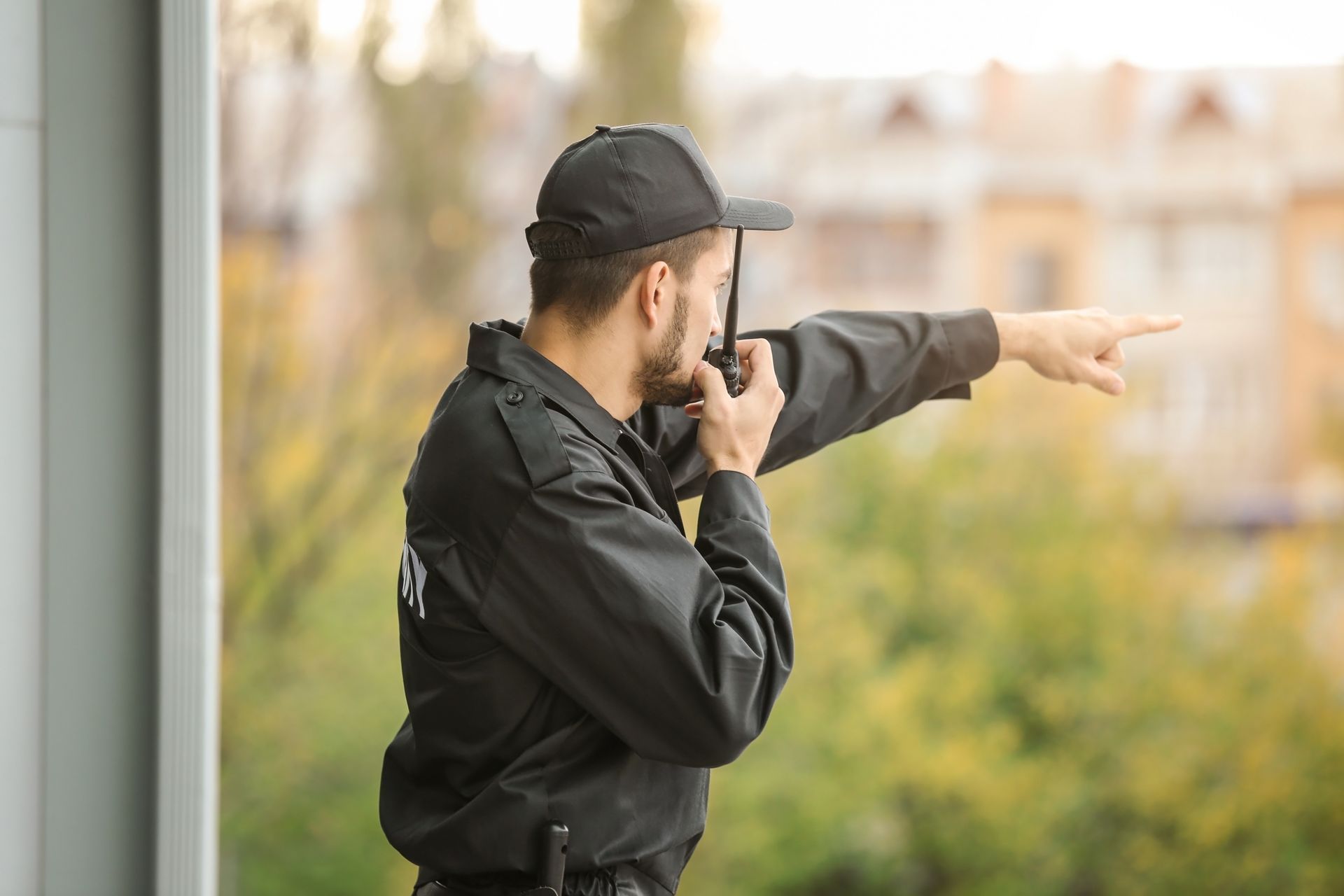 Security guard service monitoring the area and giving directions outdoors.