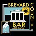 A logo for brevard county bar association with a bird and a building.
