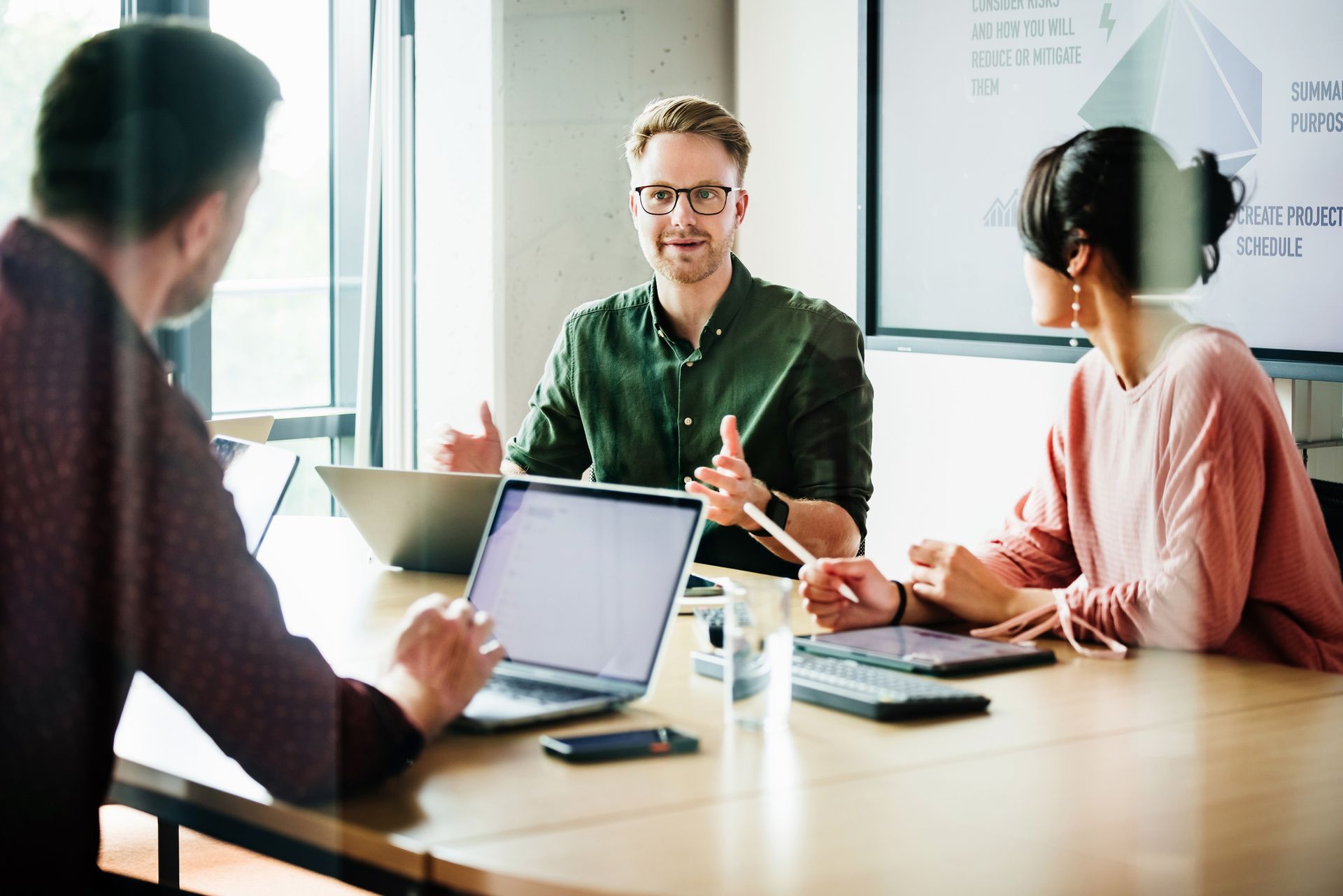 Experienced accountant assisting young couple with tax planning services in Des Moines, IA. 