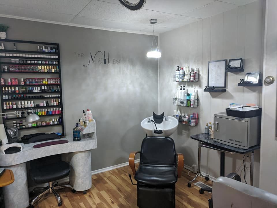 Modern nail salon with manicure table, chair, polish shelves, and wall-mounted tools