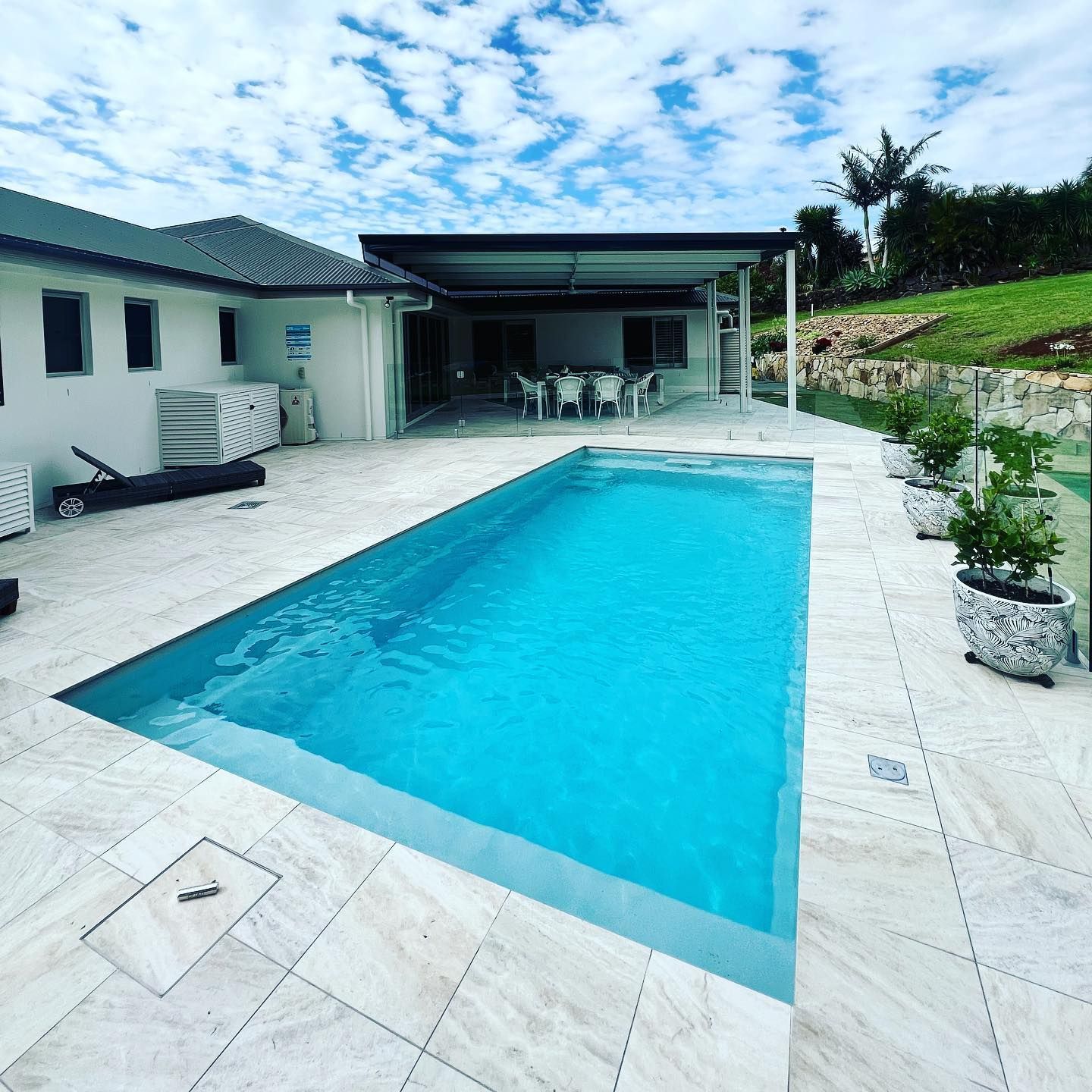 Poolside View of a House With a Pool, Gazebo, and Blue Sky — Bombs Away Pools in Coolangatta, QLD