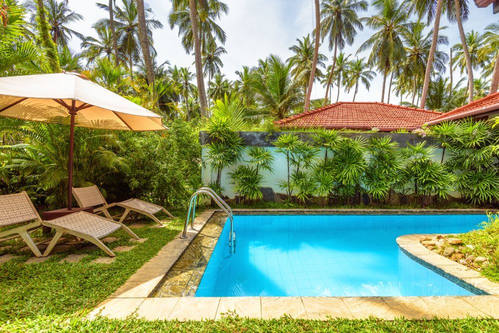 Swimming Pool With Lounge Chairs, Umbrella — Bombs Away in Burleigh Heads, QLD