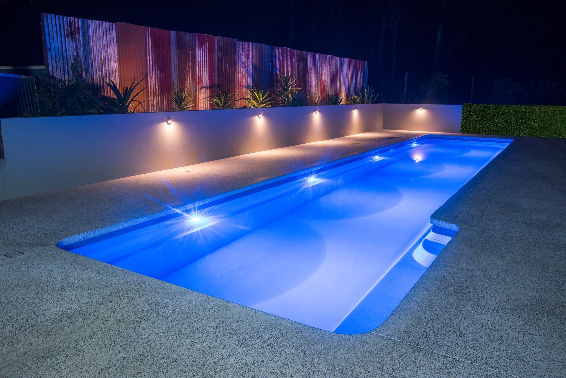 Nighttime View of a Rectangular Blue Swimming Pool — Bombs Away Pools in Coolangatta, QLD