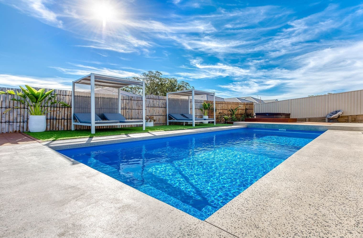 Pool With Loungers Under Pergolas — Bombs Away Pools in Coolangatta, QLD