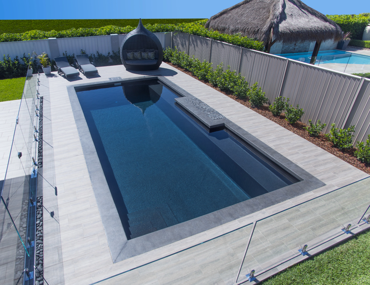 Modern Backyard Pool with Lounge Chairs and A Round Cabana by The Water — Bombs Away Pools in Coolangatta, QLD