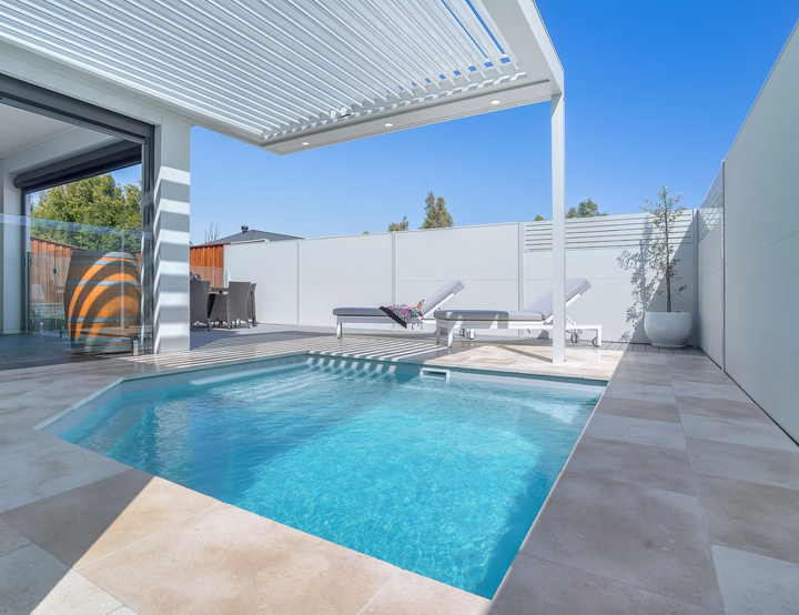 Modern Patio with A Turquoise Swimming Pool and White Lounge Chairs — Bombs Away Pools in Coolangatta, QLD
