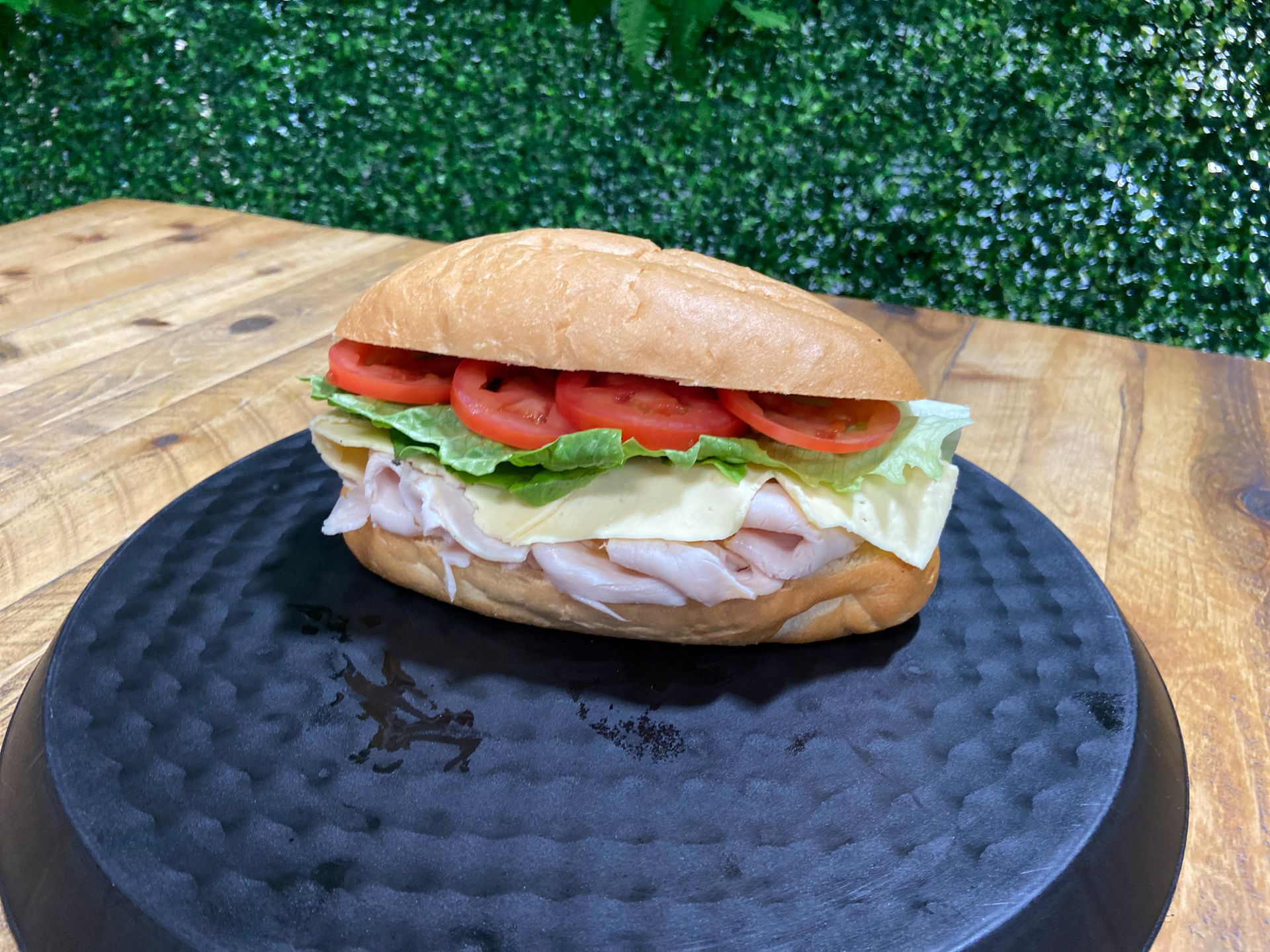 turkey sandwich on tray from Off the Rails Winery