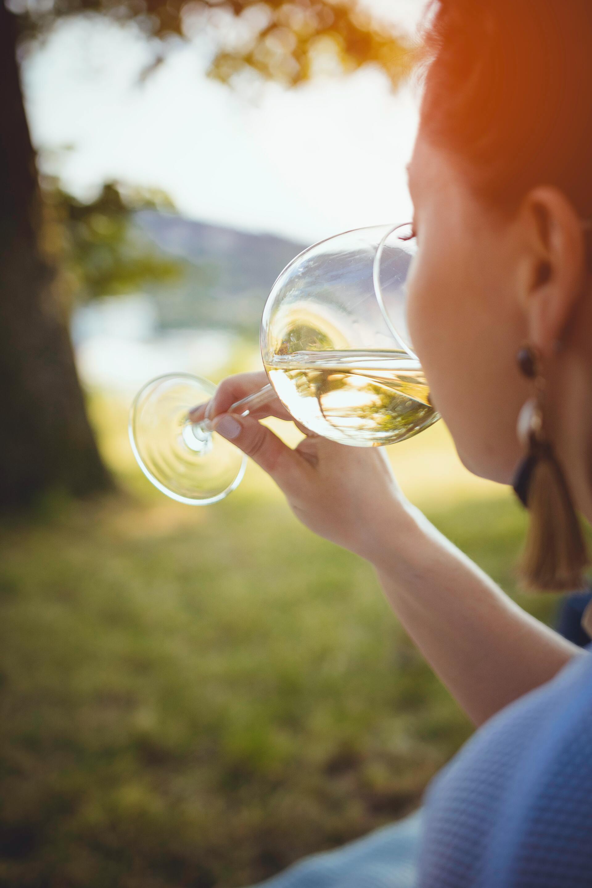 A woman drinking her glass of wine