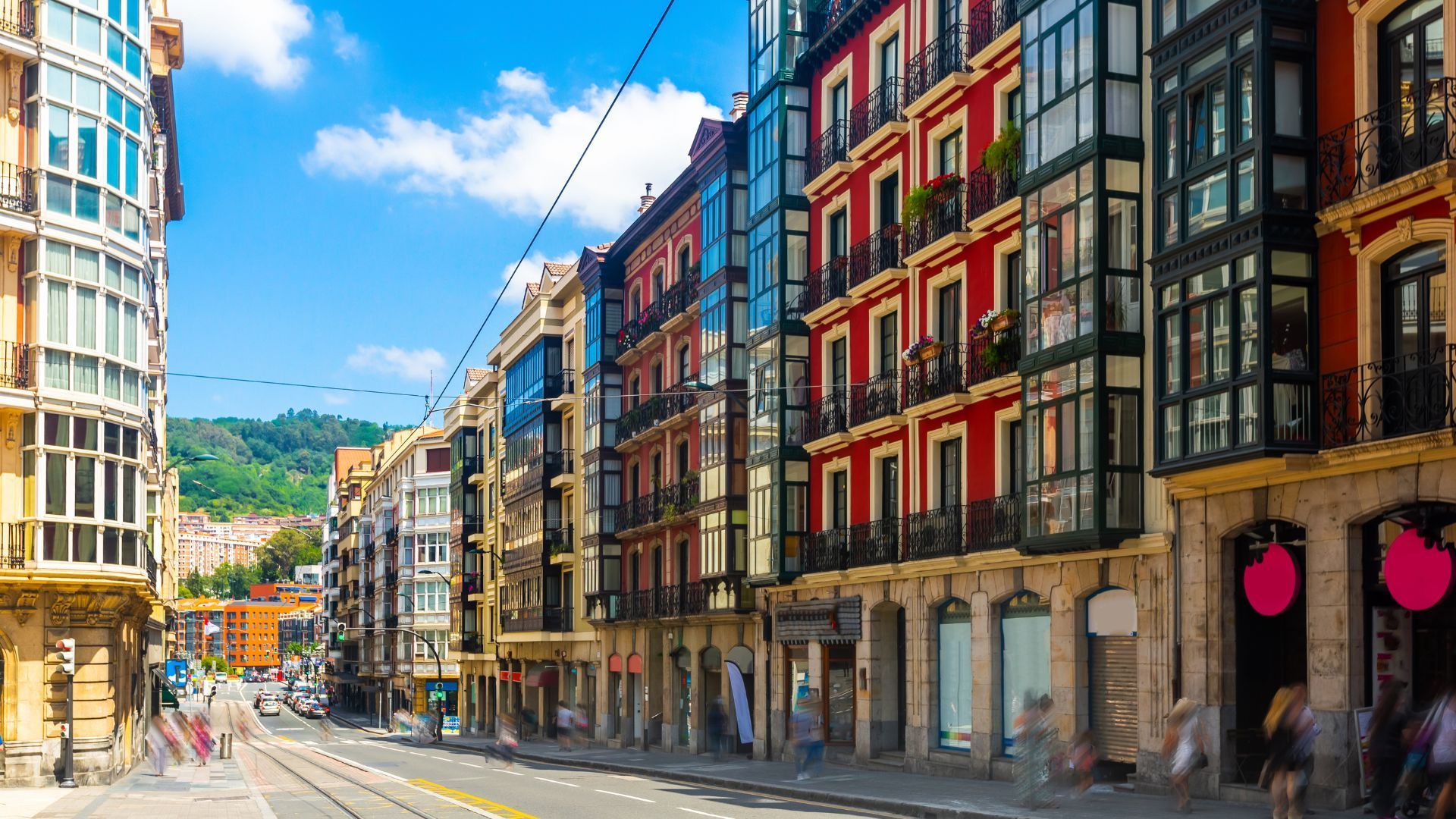 A row of colourful buildings downa street in the centre of bilbao