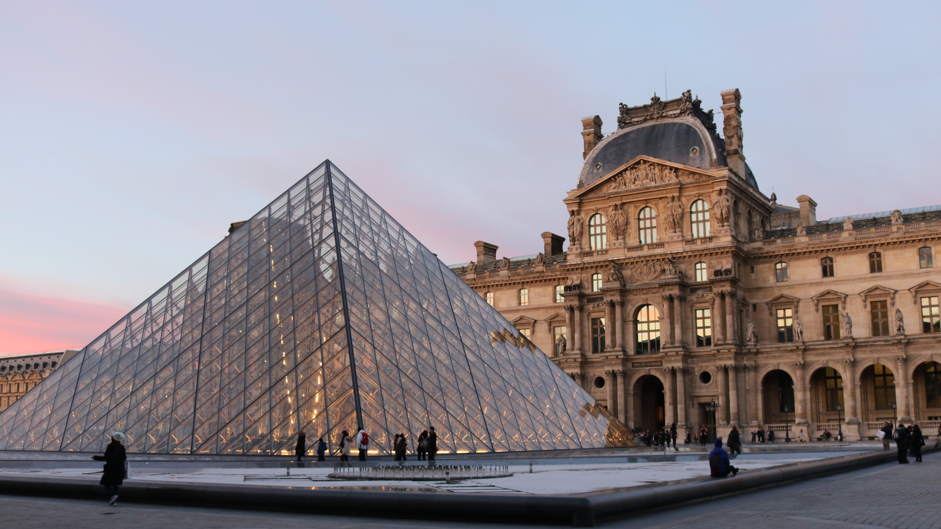 A picture of the Louvre museum at sunset