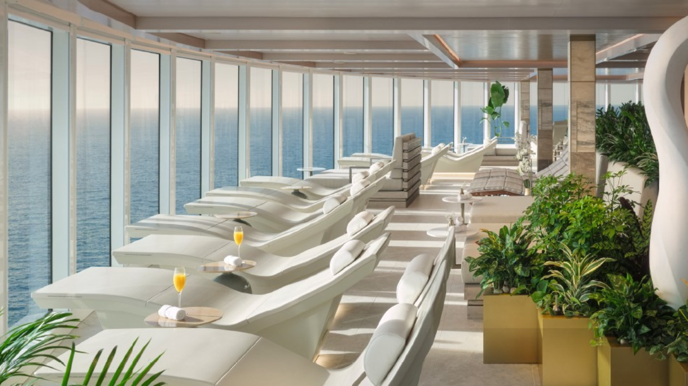 A picture of the inside of a spa with multiple lounge chairs and drinks served on the side. 