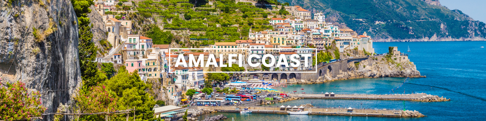 an aerial view of amalfi coast with a city in the background and a body of water in  the foreground . Barter's Travelnet 