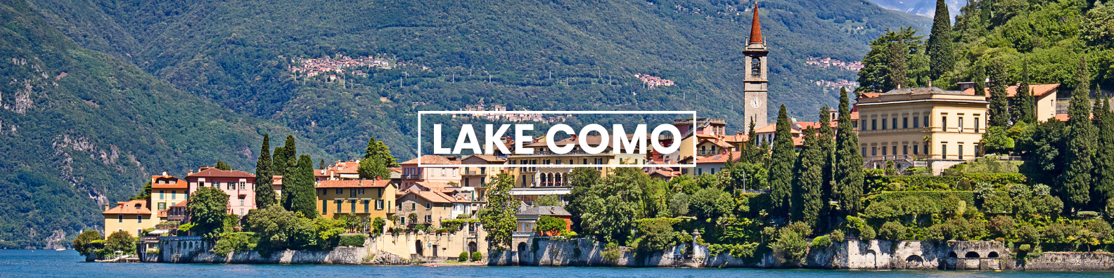 a city on a small island in the middle of a lake surrounded by trees and mountains . Barter's Travelnet 