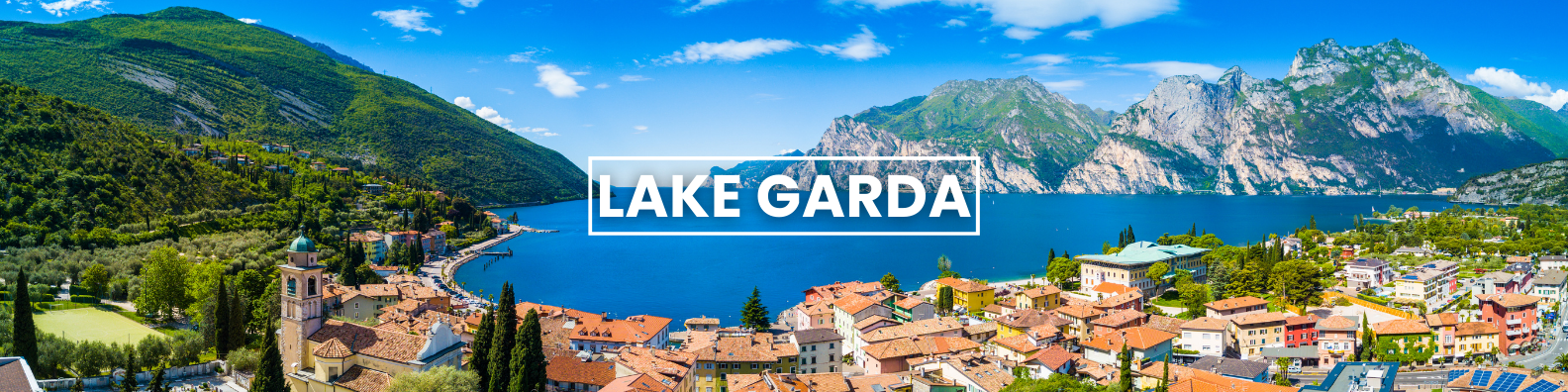 an aerial view of a lake surrounded by mountains and a city .g