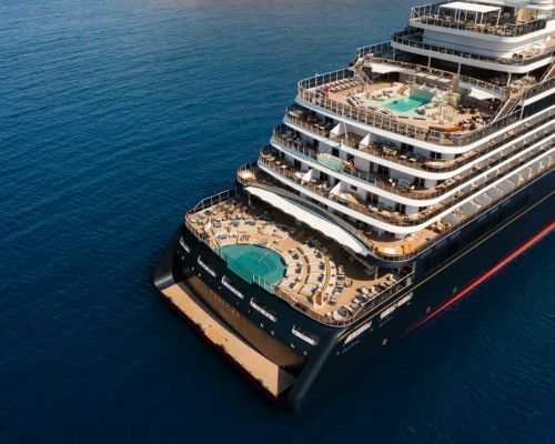 Explora II cruise ship with multiple decks and pool sailing on calm blue water