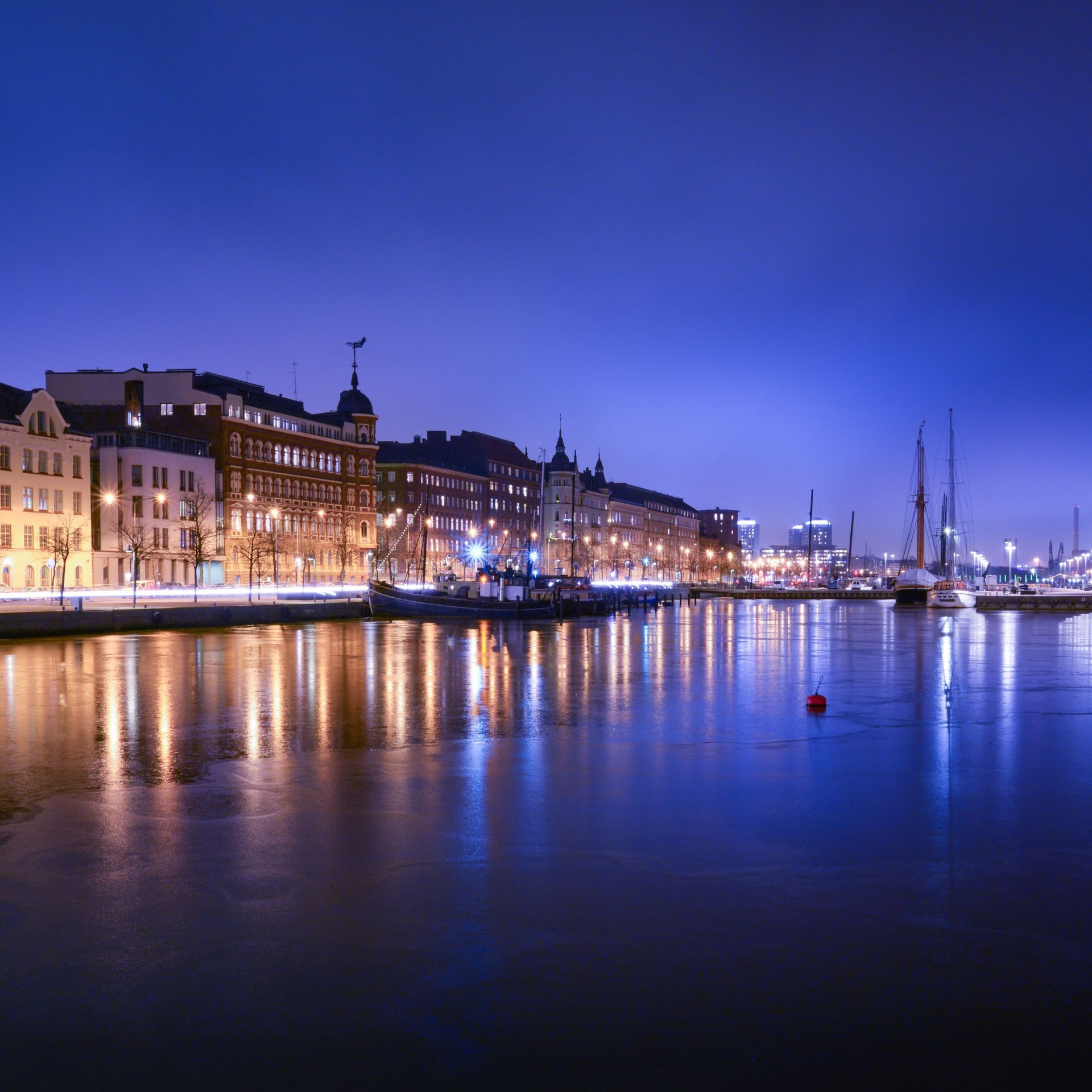 helsinki town view of townhouses with a harbour in the forefrontat dusk