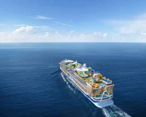 Royal Caribbean Legend of the Seas with colorful decks sailing across a deep blue ocean under a clear sky