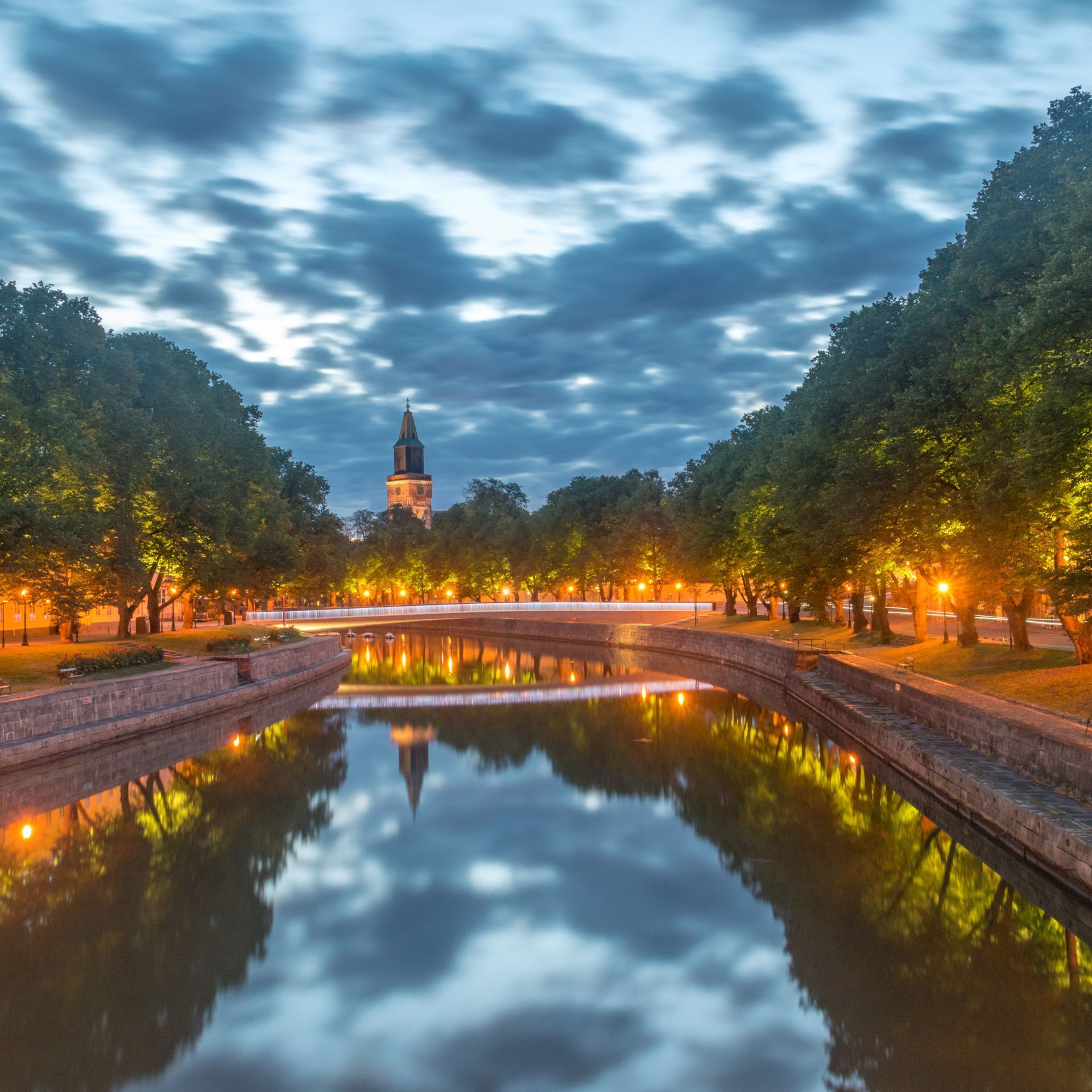 turku river the is lit up with lights and trees along the river