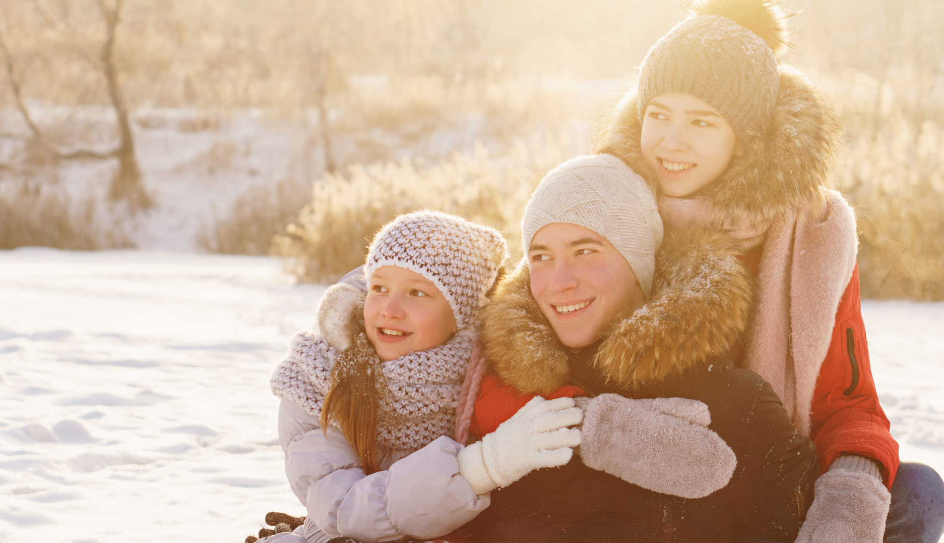 Tips and Tricks for a Magical Lapland Holiday with Kids, Family Hugging Each Other - Blog Post Barters Travelnet