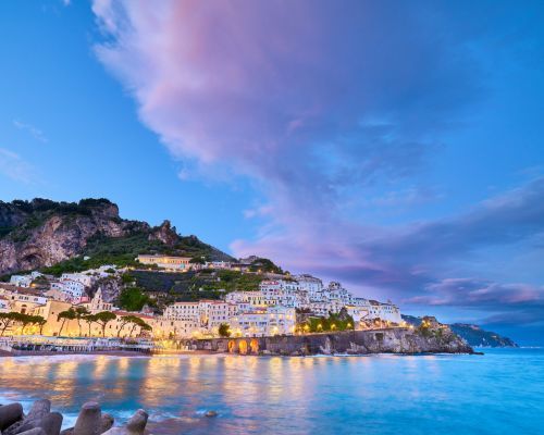 amalfi coast lit up at sunset