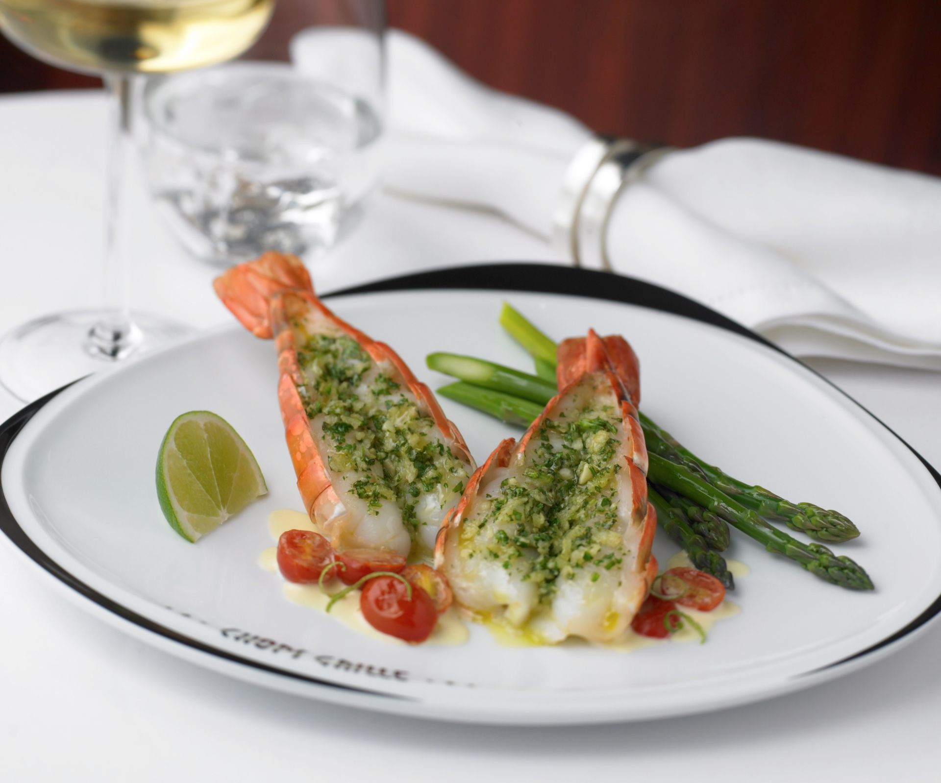 a close up of a plate of food with a glass of wine in the background Barter's Travelnet 