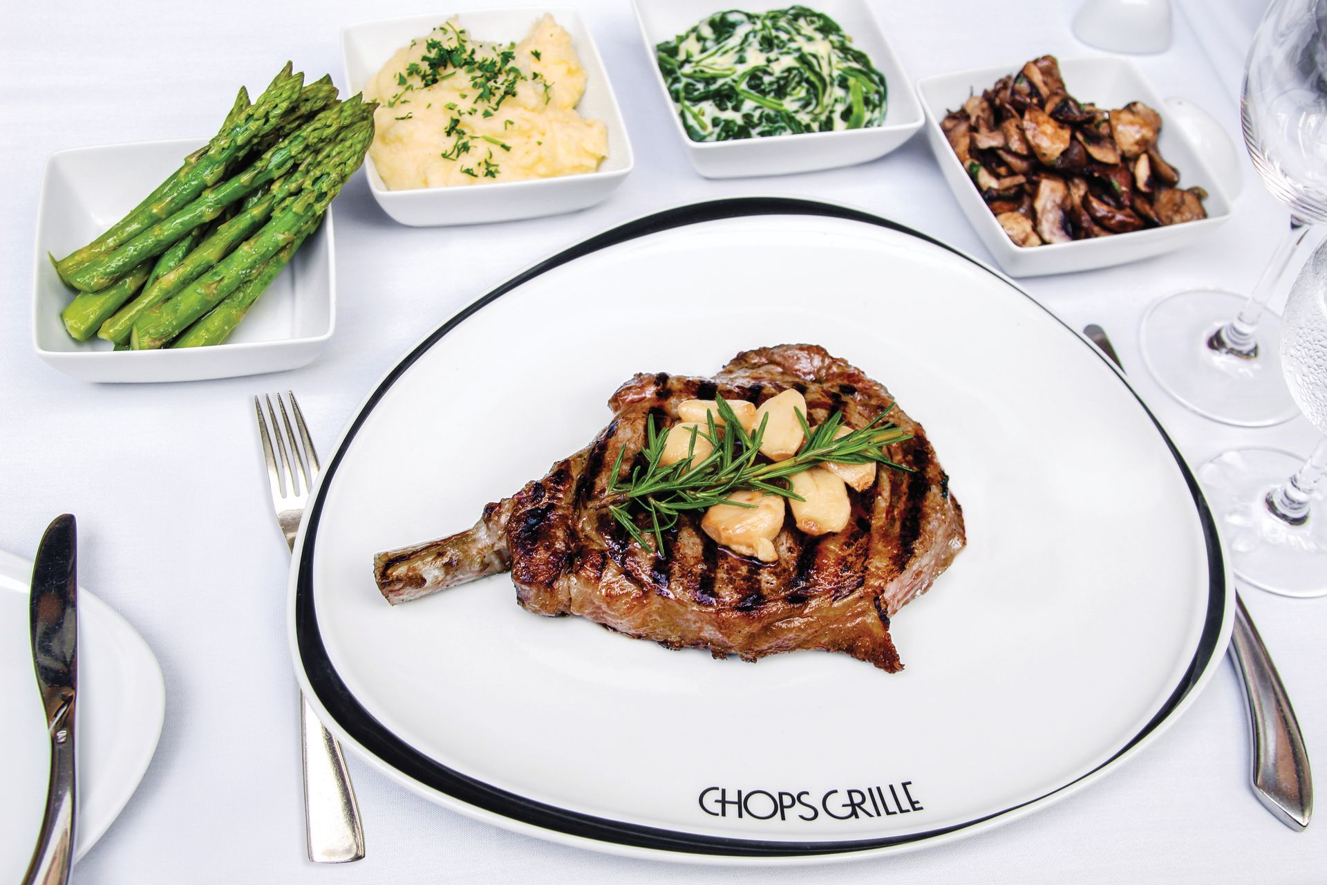 a white plate with a steak and asparagus on it Barter'sTravelnet