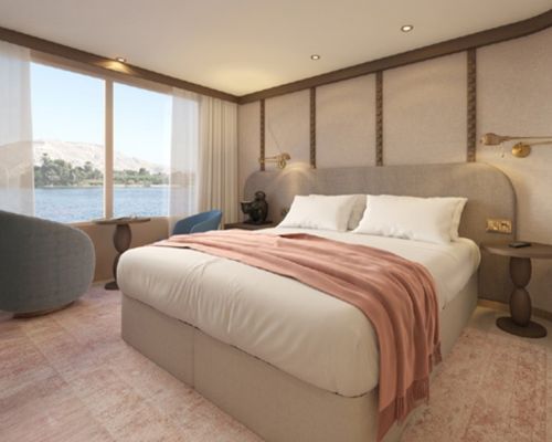 Modern Travelmarvel river cruise bedroom with a large bed, pink throw, floor-to-ceiling windows, and water view