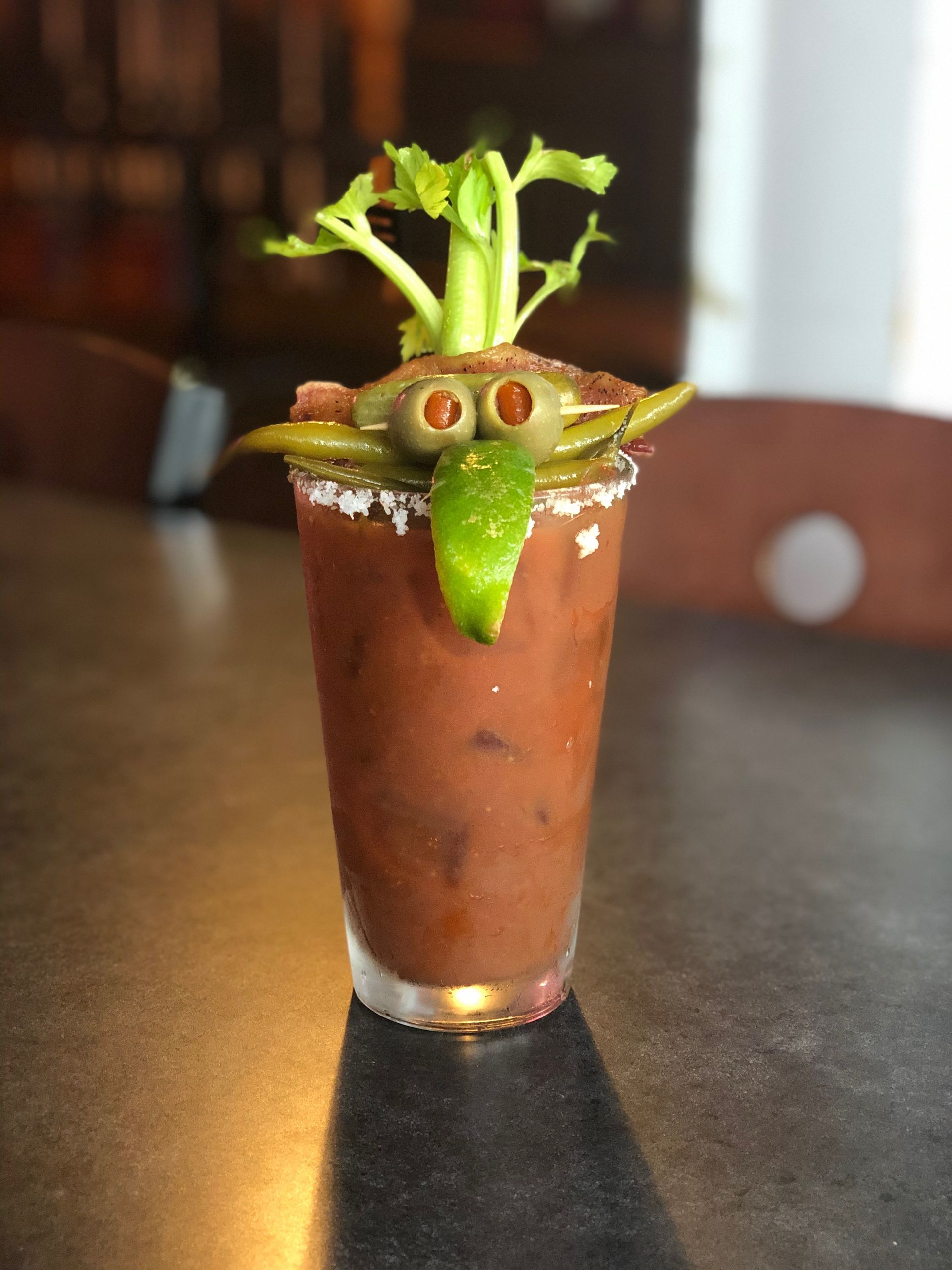 Bloody Mary cocktail with a crab-shaped garnish of olives, jalapeno, and celery.