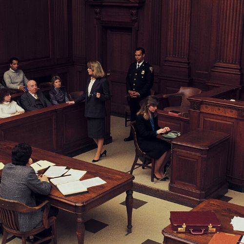 A group of people are sitting in a courtroom.