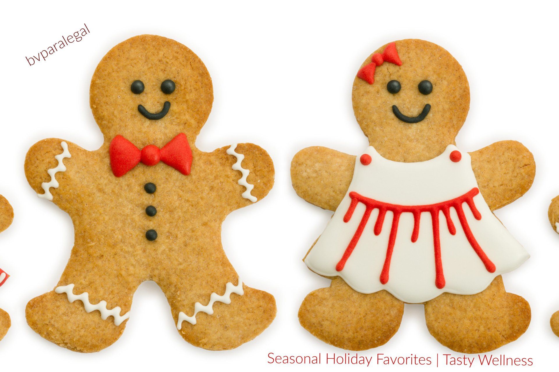A gingerbread man and a gingerbread woman are standing next to each other.