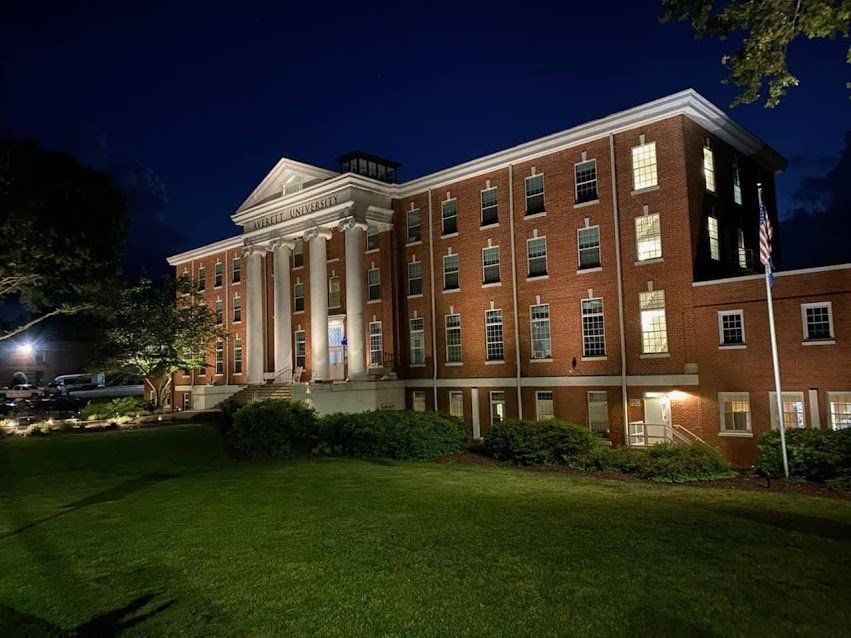 A large brick building is lit up at night