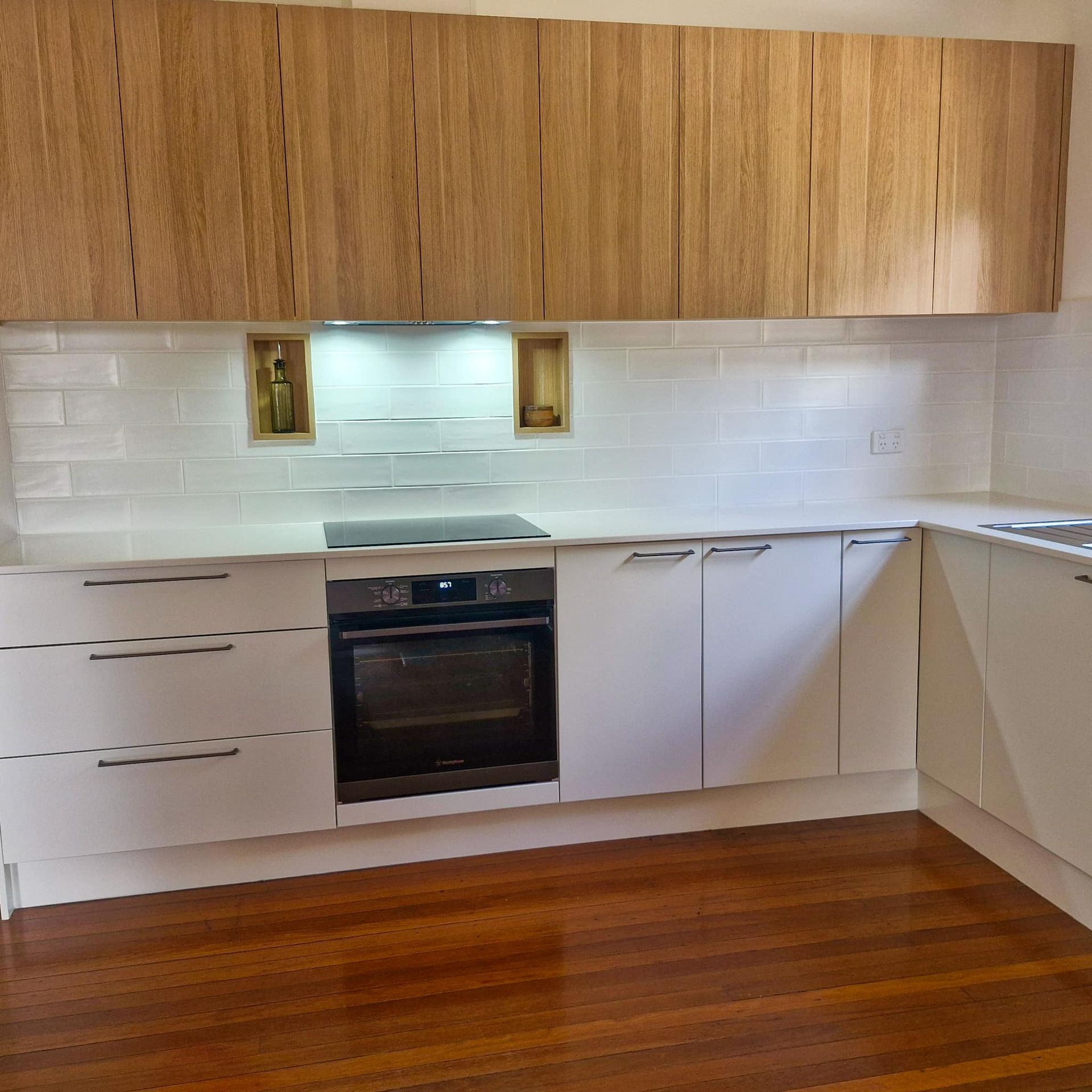 A kitchen with white cabinets and wooden cabinets — Coastal Detail Joinery in Tuncurry, NSW