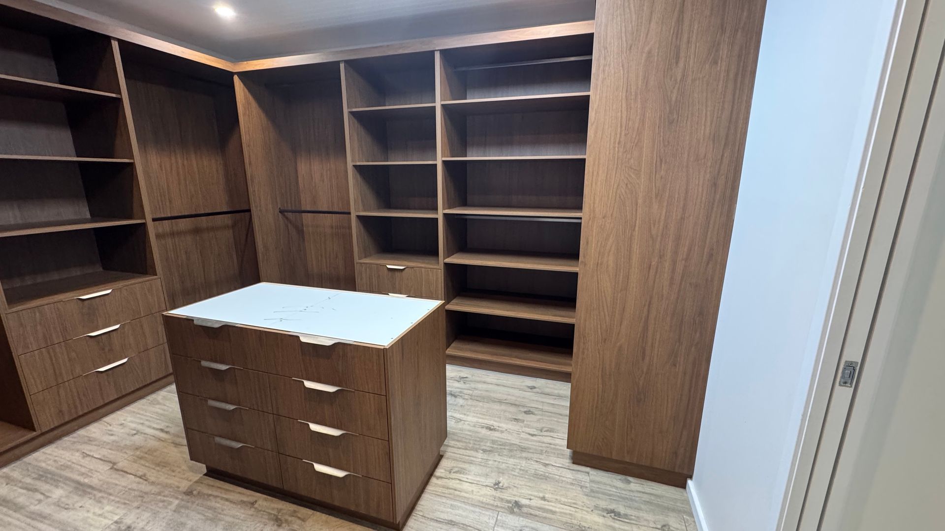 A walk in closet with lots of wooden shelves and drawers — Coastal Detail Joinery in Tuncurry, NSW