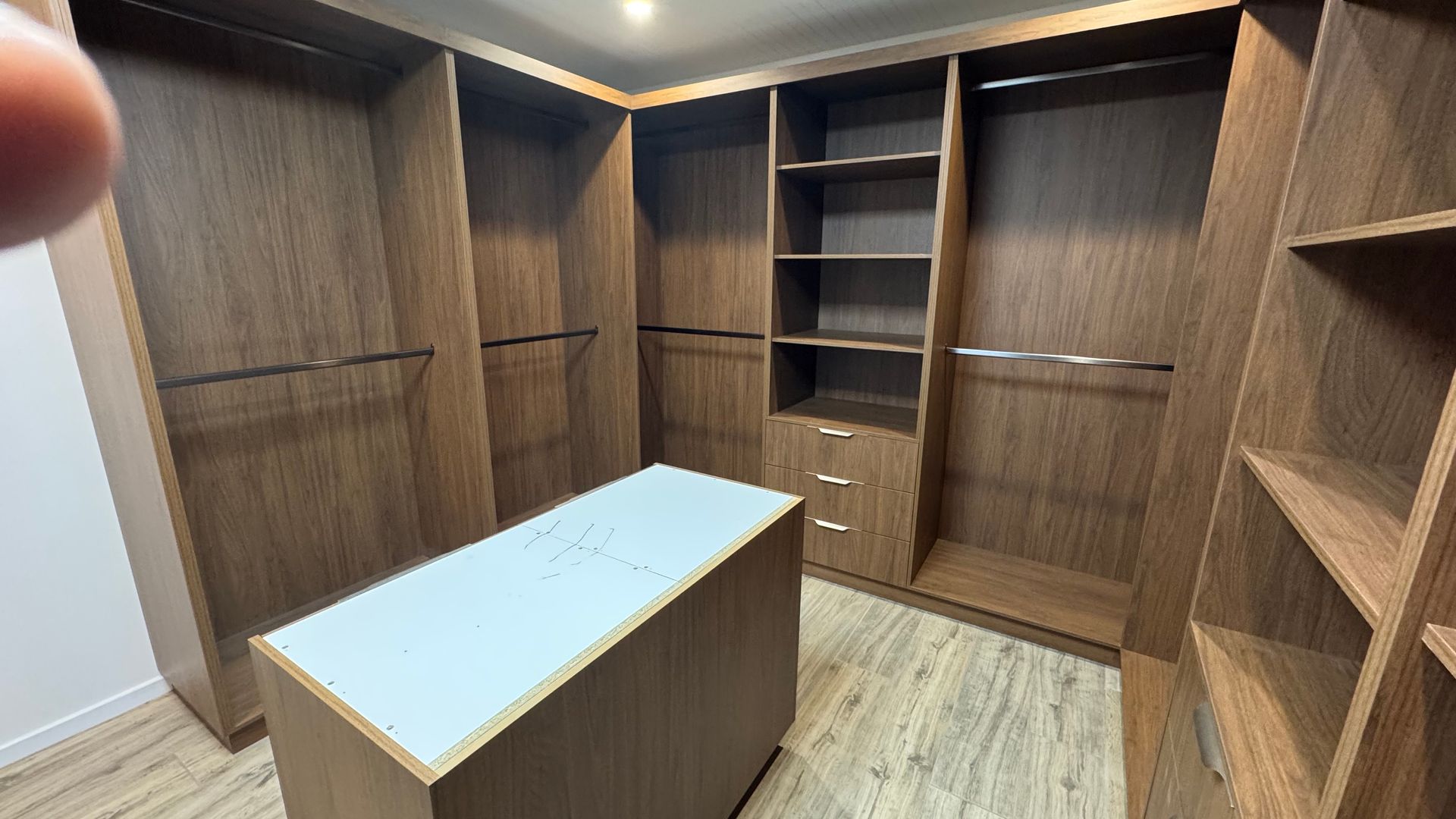 A walk in closet with lots of wooden shelves and drawers — Coastal Detail Joinery in Tuncurry, NSW