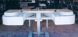 a white machine is sitting on top of a table in a garage .