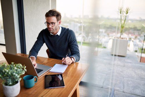 a man on a laptop exploring different types of ups systems